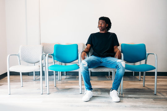 Gen Z boy sitting in doctors wait area