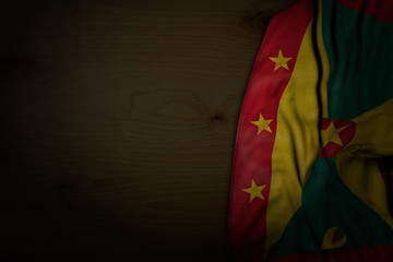 pretty any occasion flag 3d illustration. - dark image of Grenada flag with large folds on dark wood with free space for your content