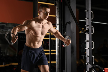Fototapeta na wymiar Sporty muscular man training in gym