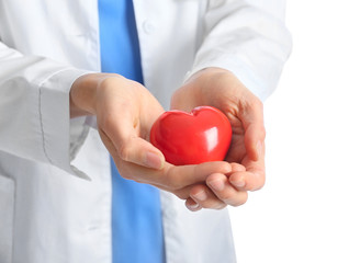 Female cardiologist with red heart on white background, closeup
