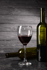 Bottles and glass of wine on table. Concept of alcoholism