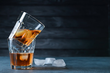 Glasses of whiskey on table. Concept of alcoholism
