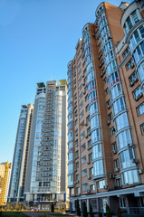 Fototapeta na wymiar The new multi-storey residential building on blue sky background, Kyiv, Ukraine