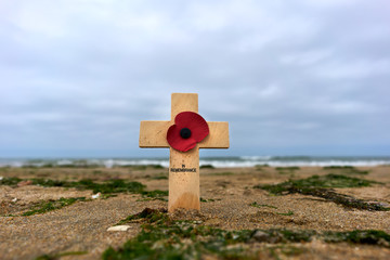 Wooden cross in the sand at Utah Beach in the Normandy to remember the deaths of the second world war