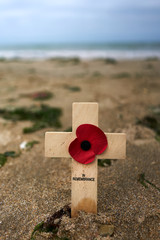 Wooden cross in the sand at Utah Beach in the Normandy to remember the deaths of the second world war