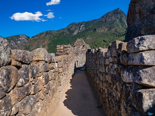 Narrow streets,  walls and houses located within the Machu Picchu complex, Cusco region, Peru