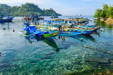 Fototapeta na wymiar Fishing boats parking at Sendang Biru beach, Malang, East Java