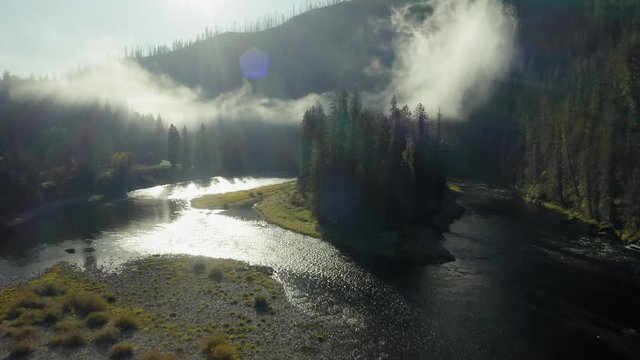 Aerial flying down the Lochsa river and forest with morning fog covering the the hills. Nez Perce Clearwater National Forests, Idaho, USA.