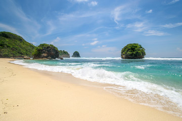 Batu Leter tropical beach with white sand and blue sea in East Java, Indonesia