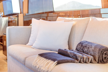 Selective focus shot of white pillows on the couch on the yacht
