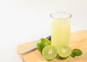 Glass of fresh lime juice on white background.