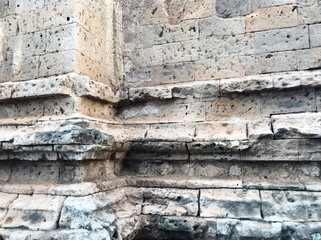 Grunge dirty old brick stone wall exterior on ancient temple architecture