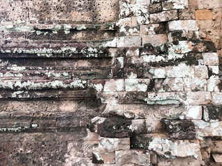 Grunge dirty old brick stone wall exterior on ancient temple architecture