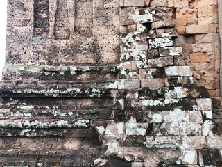 Grunge dirty old brick stone wall exterior on ancient temple architecture