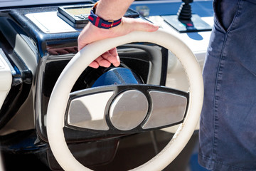 Closeup shot of a person steering the yacht