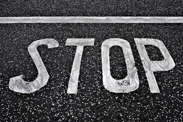 Word 'STOP' in large white letters on black background.