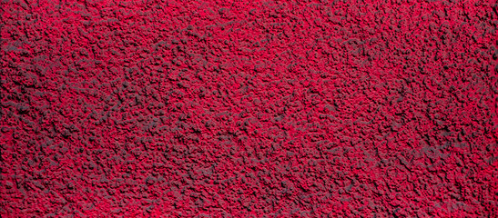 Murky dimpled red burgundy surface, an empty surface with space for text for backgrounds and backdrops in web design.