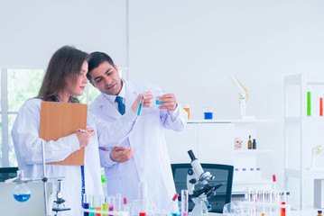 In Modern Laboratory Young Female Scientist Has Discussion with Young Male Laboratory Assistant. He...