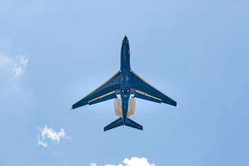 Blue jet plane with two rear turbines taking off
