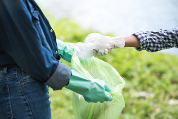 asian women volunteer help garbage collection charity environment river area. Improving environment, closeup. Everyone has to help preserve the ecology on earth. (Environment concept)