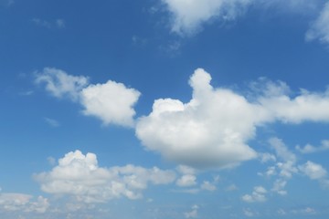 Naklejka na ściany i meble Beautiful fluffy clouds in blue sky, natural background