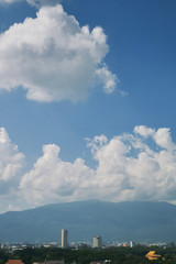 white cloud on clear blue sky above the town
