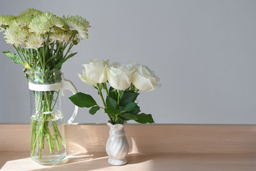 white rose blossom decoration in home, beautiful flower blooming in small vase put on wooden table with sunlight  the morning day