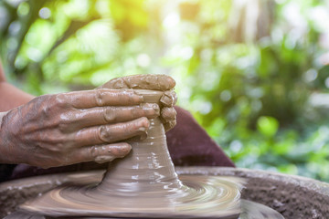 Hands working on pottery wheel