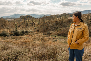 Naklejka premium Girl walks in a tropical forest, in the summer