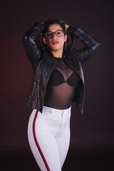 Fototapeta na wymiar Young girl model posing in black background studio with black transparency t-shirt