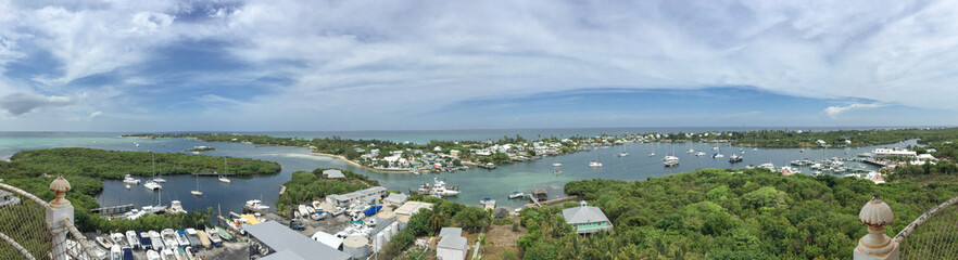 Fototapeta na wymiar Panoramic image of Hope Town, Abaco, Bahamas with boats and water; landscape