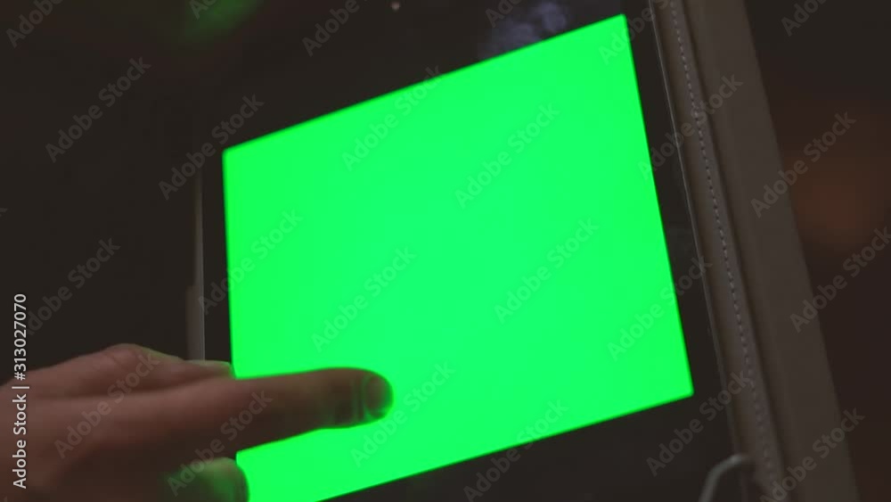 Poster shooted in slow motion showing man's hands browsing social media or playing with a mobile tablet at 