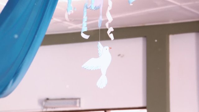 A White Paper Dove Hanging From The Ceiling In A Public School In Argentina. 