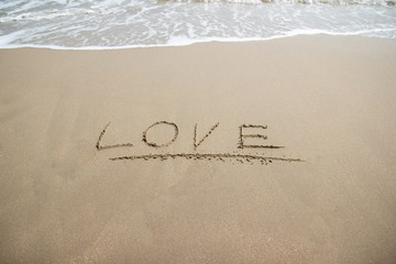 Fototapeta na wymiar word Love on sand at the beach, concept symbol of valentine day