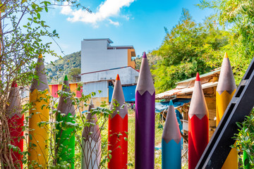 Colorful crayon pencils placed as a fence surrounding a garden