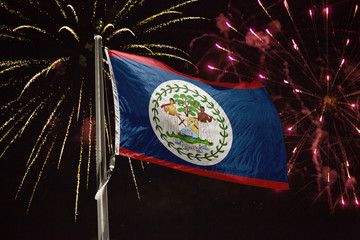 Belize flag blowing in the wind at night