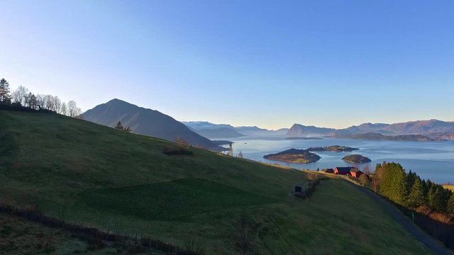 Halse in &Oslash;rsta in Norway. Filmed with drone in the spring. In the fjord you can see the island Raud&oslash;ya and the islet Raud&oslash;yholmen. This a great example the nature in western Norway. Sunnm&oslash;re.