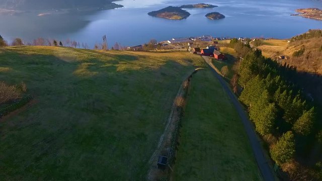 Halse in &Oslash;rsta in Norway. Filmed with drone in the spring. In the fjord you can see the island Raud&oslash;ya and the islet Raud&oslash;yholmen. This a great example the nature in western Norway. Sunnm&oslash;re.