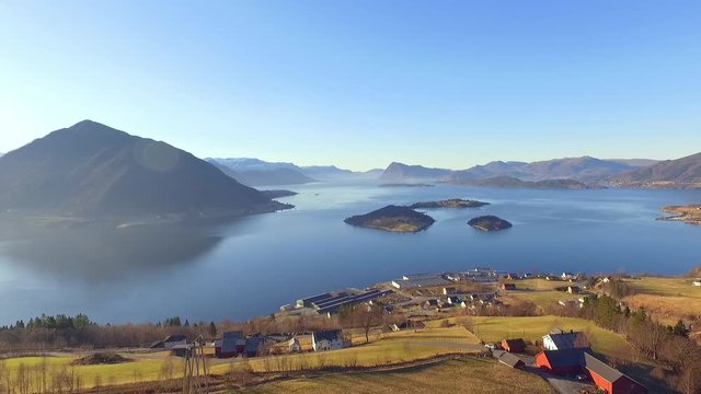 Halse in &Oslash;rsta in Norway. Filmed with drone in the spring. In the fjord you can see the island Raud&oslash;ya and the islet Raud&oslash;yholmen. This a great example the nature in western Norway. Sunnm&oslash;re.