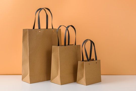 mockup of blank craft package or Brown paper shopping bag with handles
