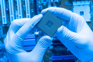 close up the scientist hand holding a cpu processor chip, working in the laboratory