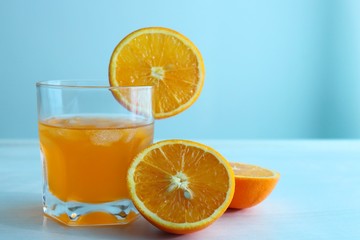 Orange fresh drink, glass of orange juice and ripe citrus fruits on white background