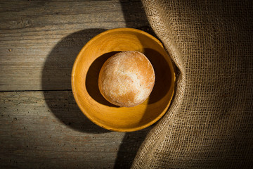 Bread roll in a wooden plate