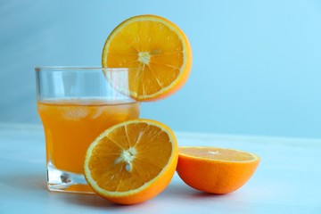 Orange fresh drink, glass of orange juice and ripe citrus fruits on white background