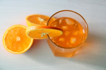 Orange fresh drink, glass of orange juice and ripe citrus fruits on white background