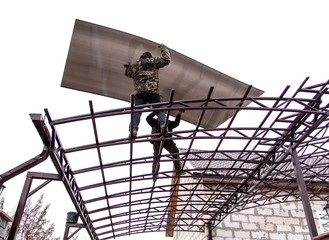A worker mounts a metal canopy