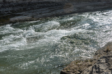 the sea coast in the afternoon with waves and splashes, the sea coast with stones.