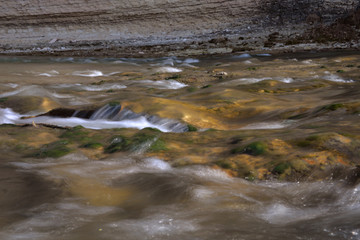 the sea coast in the afternoon with waves and splashes, the sea coast with stones.