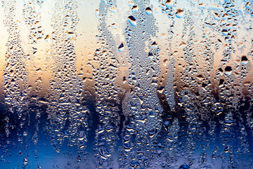 A foggy window at sunset as an abstract background