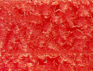 Snowflakes on red metal as a background